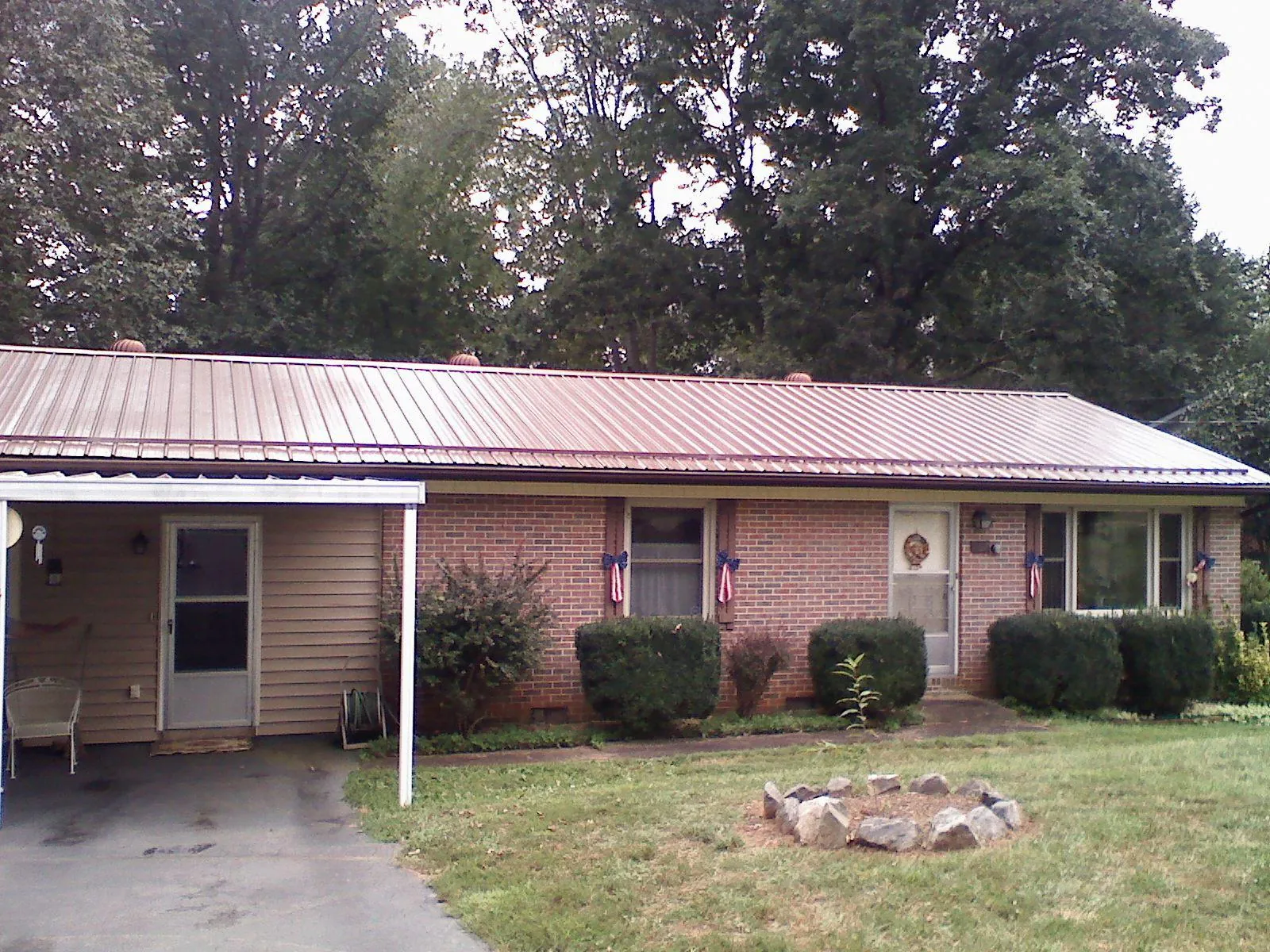Bronze metal roof and carport on a brick ranch home — Roof Repair work by our crew in Pedro Bay